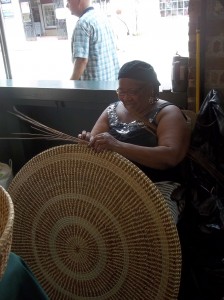 Charleston women weaving a traditional basket out of palmetto leaves. A local form of art featured in the Smithsonian. 